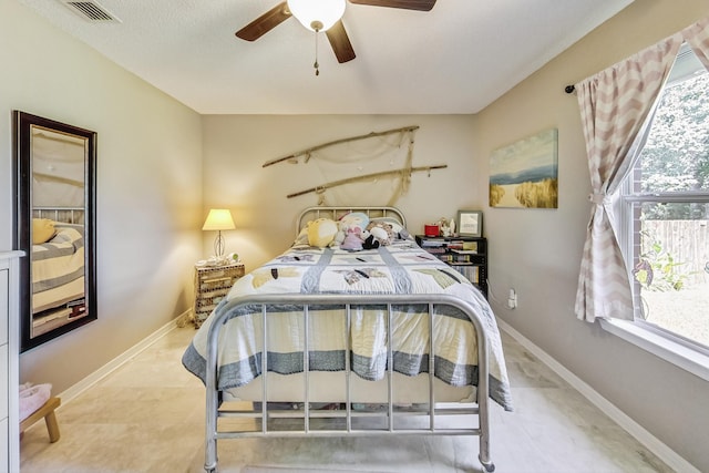 bedroom with ceiling fan and light tile patterned floors