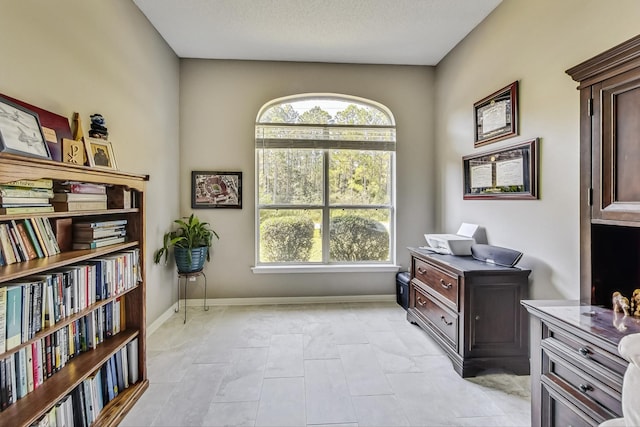 office space with light tile patterned flooring and a textured ceiling