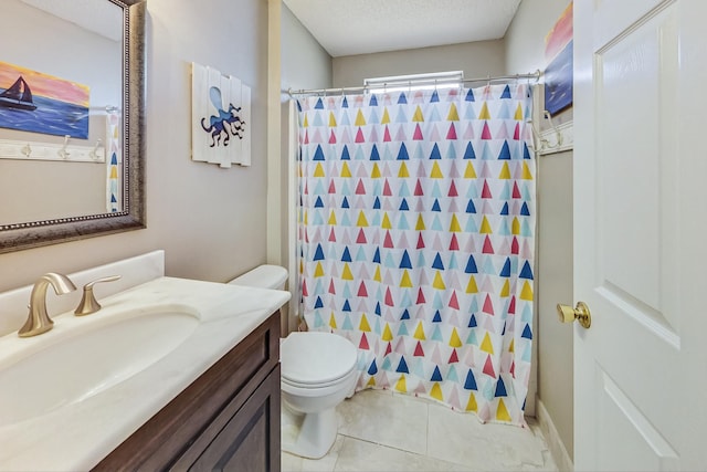 bathroom featuring tile patterned flooring, toilet, a textured ceiling, and vanity