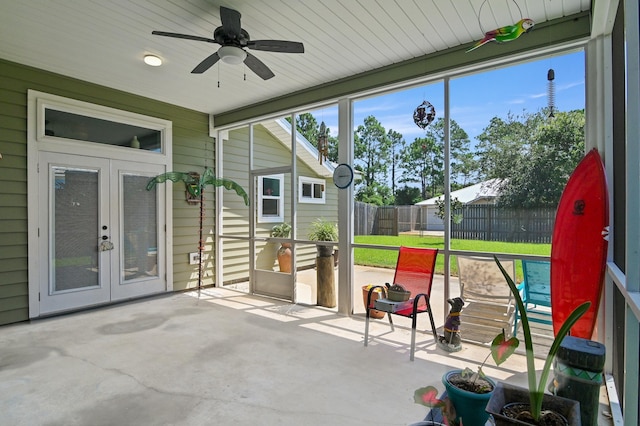 sunroom featuring ceiling fan and french doors