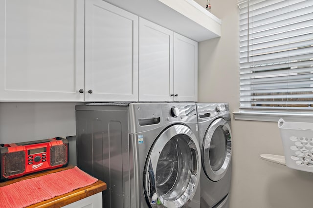 laundry room featuring cabinets and washing machine and clothes dryer