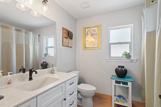 bathroom featuring tile patterned floors, vanity, and toilet