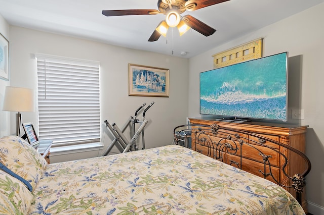 bedroom with ceiling fan and multiple windows