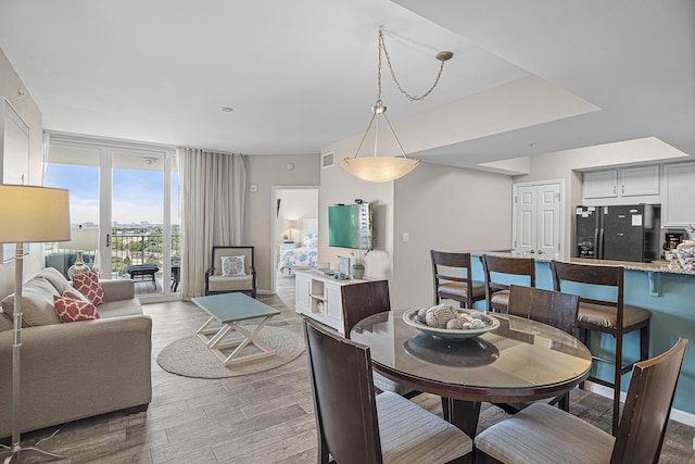 dining area with hardwood / wood-style floors and floor to ceiling windows