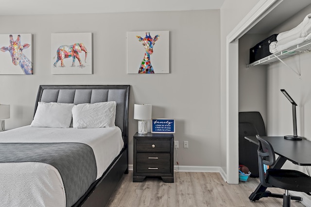 bedroom featuring light wood-type flooring and baseboards