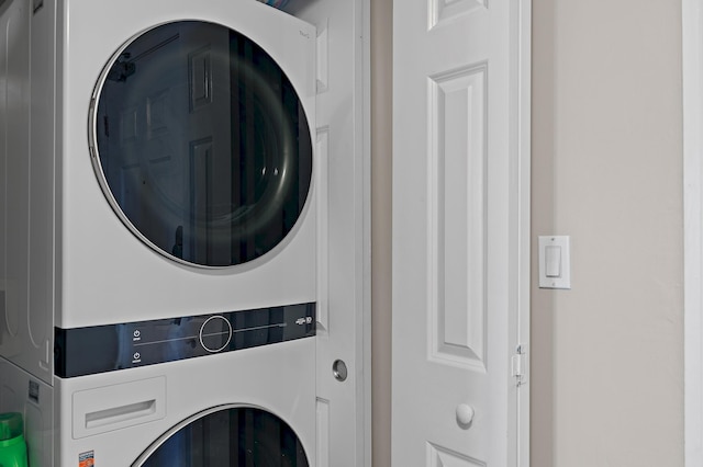 laundry area with stacked washer and dryer and laundry area