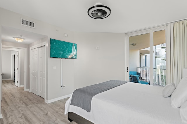 bedroom with light wood finished floors, baseboards, visible vents, access to exterior, and a closet