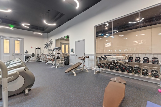 workout area featuring wainscoting and visible vents