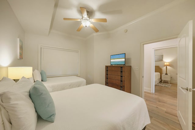 bedroom with ceiling fan, ornamental molding, and light hardwood / wood-style floors