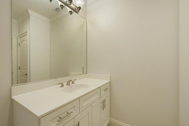 bathroom featuring vanity and ornamental molding