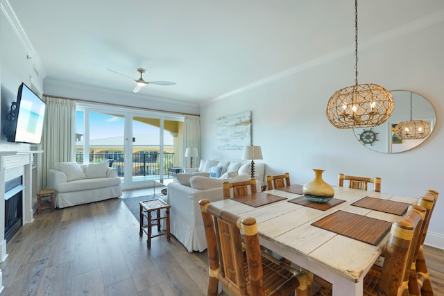 dining area featuring ceiling fan, wood-type flooring, and crown molding