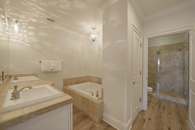 full bathroom with dual bowl vanity, toilet, hardwood / wood-style floors, and ornamental molding