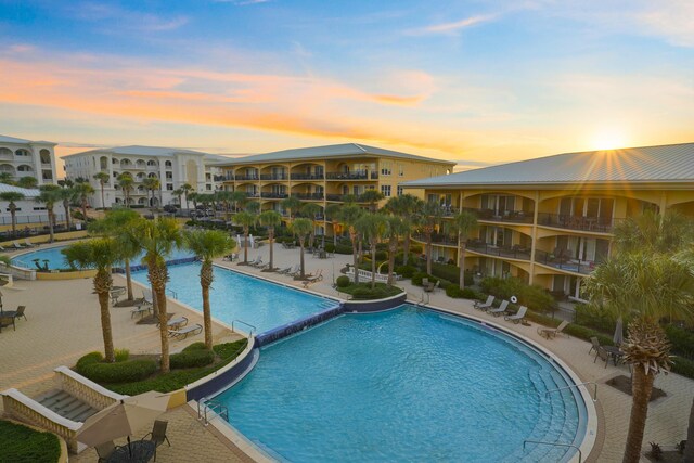 view of pool at dusk