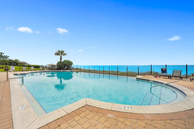 view of swimming pool with a water view