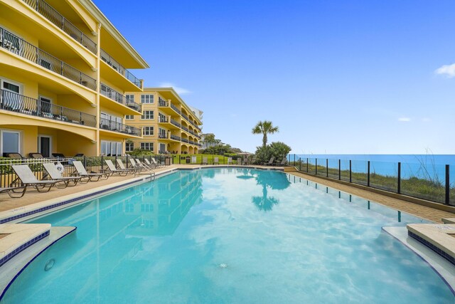 view of swimming pool with a water view