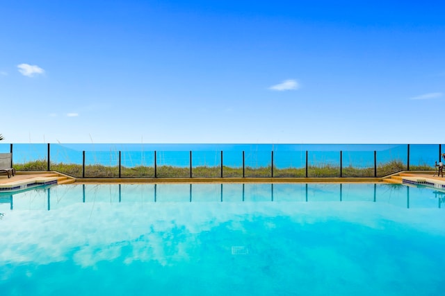 view of swimming pool featuring a water view