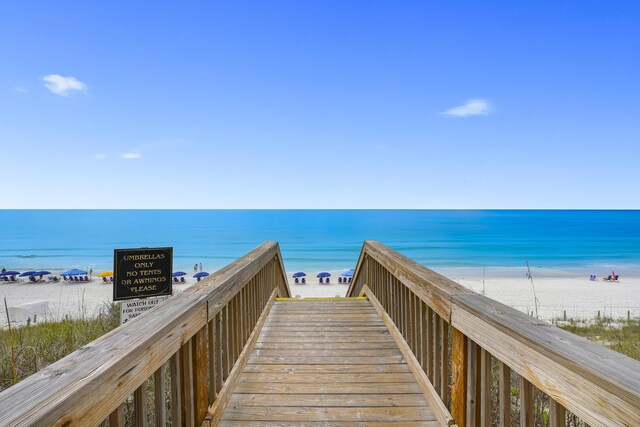 surrounding community featuring a water view and a view of the beach