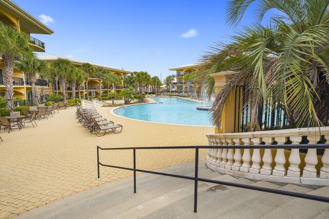 view of pool with a patio area and pool water feature