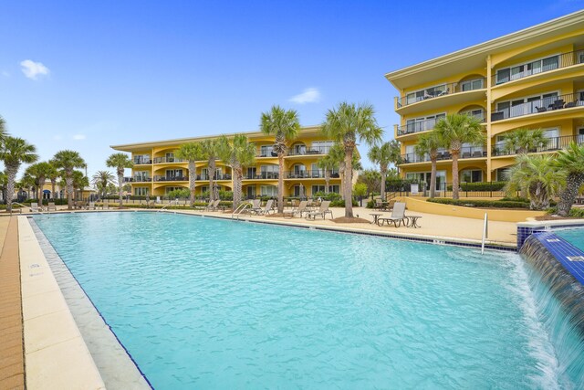 view of swimming pool featuring pool water feature