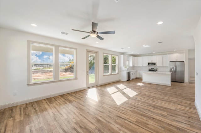 76 Azalea Dr, Freeport, FL 32439 - unfurnished living room featuring recessed lighting, a ceiling fan, light wood-style floors, and baseboards