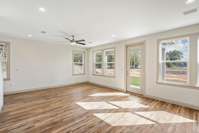 76 Azalea Dr, Freeport, FL 32439 - unfurnished room featuring healthy amount of natural light, wood finished floors, baseboards, a ceiling fan, and recessed lighting