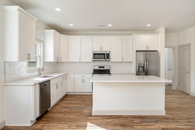 76 Azalea Dr, Freeport, FL 32439 - kitchen with appliances with stainless steel finishes, a sink, a center island, white cabinets, and recessed lighting