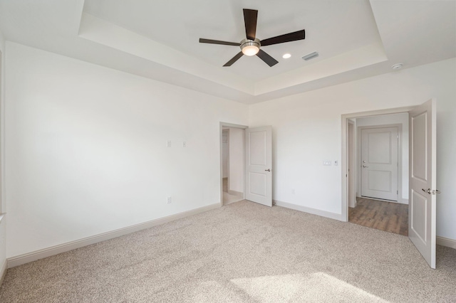 76 Azalea Dr, Freeport, FL 32439 - unfurnished bedroom featuring a raised ceiling, light colored carpet, baseboards, and ceiling fan