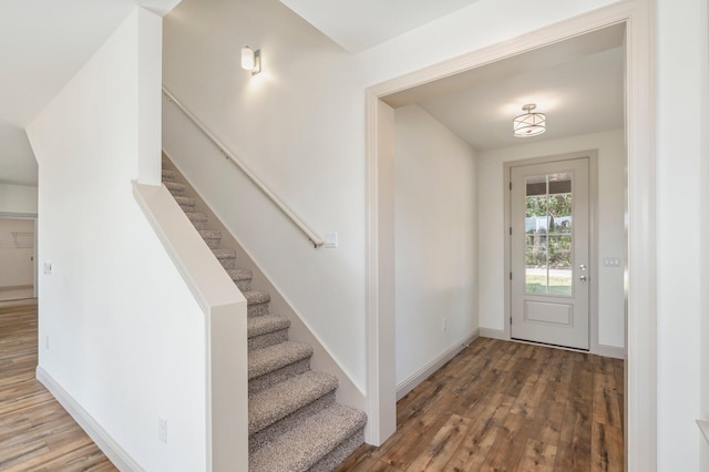 76 Azalea Dr, Freeport, FL 32439 - foyer featuring wood finished floors, stairway, and baseboards