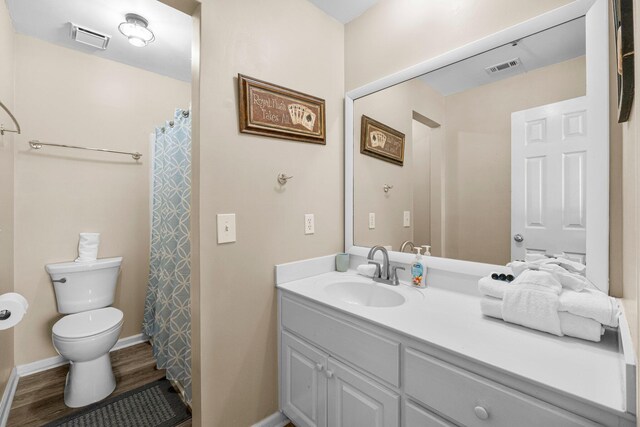 bathroom featuring vanity, hardwood / wood-style floors, and toilet