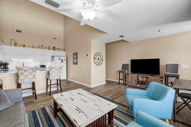 living room featuring ceiling fan and wood-type flooring