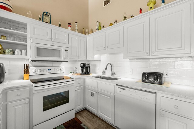 kitchen with sink, decorative backsplash, and white appliances