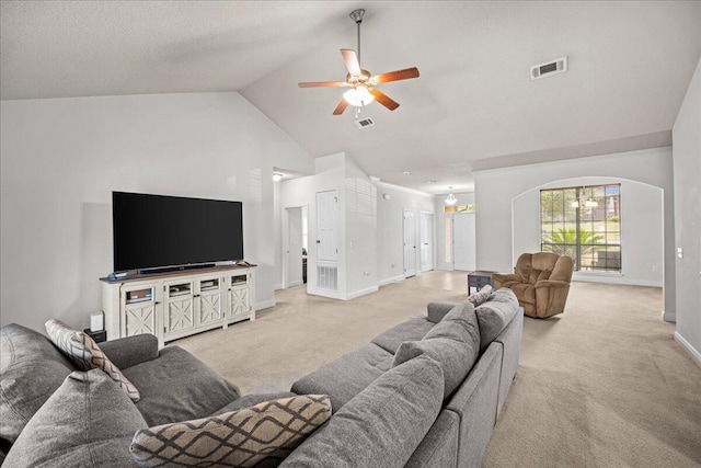 living room featuring ceiling fan, high vaulted ceiling, and light carpet