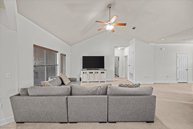 living room featuring ceiling fan, high vaulted ceiling, a textured ceiling, and light carpet