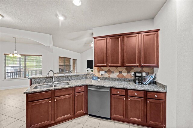 kitchen with lofted ceiling, dishwasher, light tile patterned floors, sink, and kitchen peninsula