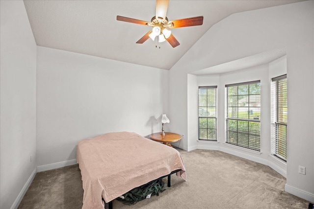 carpeted bedroom with ceiling fan and lofted ceiling