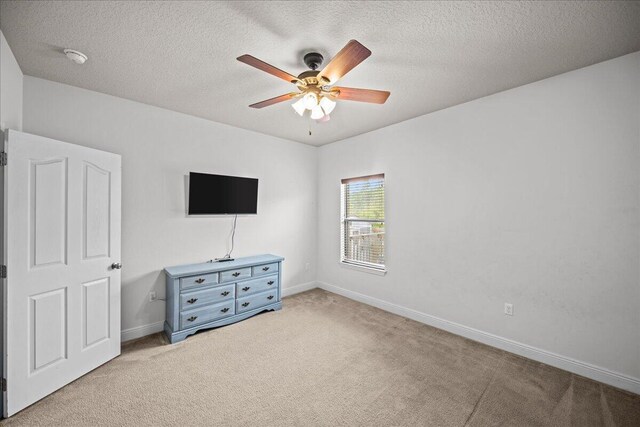 carpeted bedroom with a textured ceiling and ceiling fan