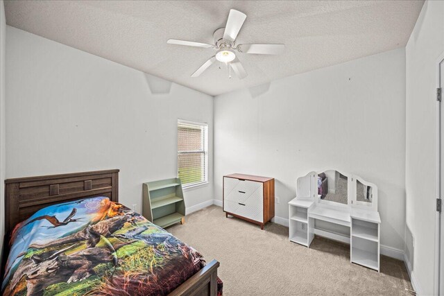 carpeted bedroom with a textured ceiling and ceiling fan