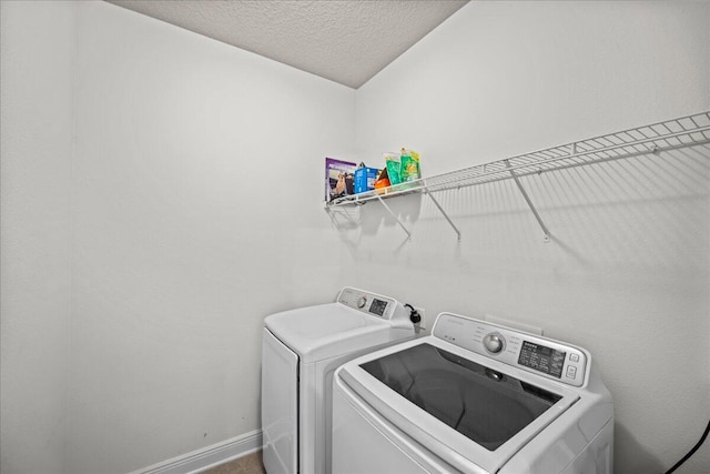 washroom with separate washer and dryer and a textured ceiling