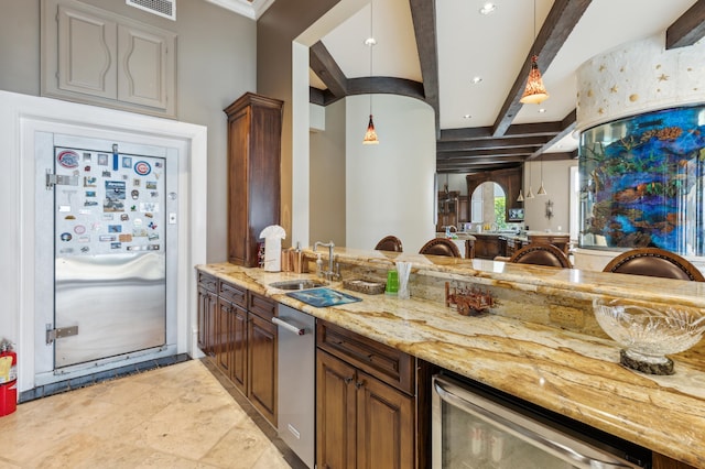 kitchen featuring pendant lighting, beverage cooler, light stone countertops, sink, and beamed ceiling