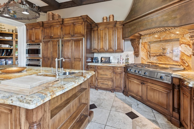 kitchen featuring backsplash, sink, custom exhaust hood, light stone countertops, and stainless steel appliances