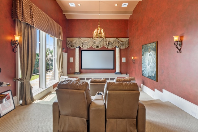 cinema room with baseboards, a notable chandelier, a towering ceiling, and carpet flooring
