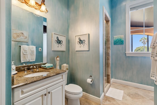 full bathroom featuring toilet, vanity, a shower stall, tile patterned flooring, and baseboards