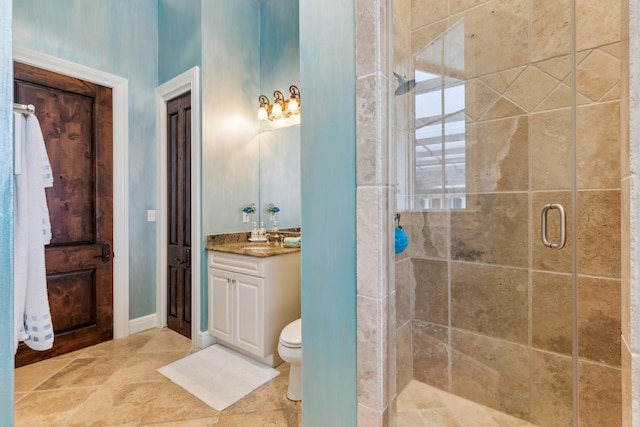 bathroom with an enclosed shower, toilet, vanity, and tile patterned floors