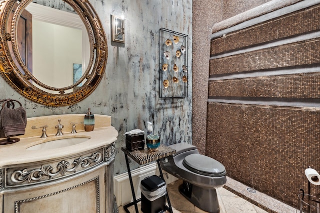 bathroom featuring tile patterned floors, vanity, and toilet