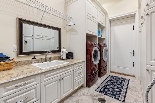 washroom featuring sink, light tile patterned flooring, separate washer and dryer, and cabinets