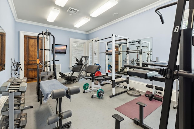 exercise room featuring crown molding and visible vents