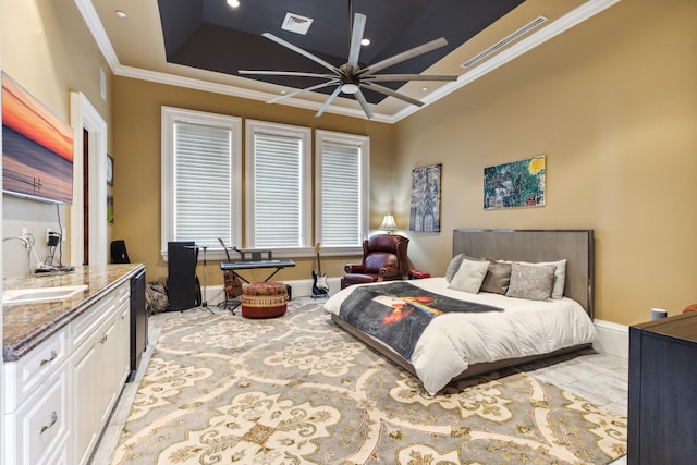 bedroom featuring ceiling fan, a raised ceiling, and crown molding