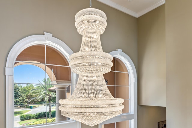 room details featuring ornamental molding and a chandelier