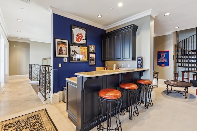 bar with sink, crown molding, light tile patterned flooring, and light stone countertops