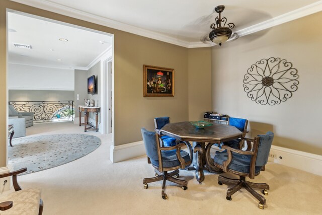 dining area with visible vents, crown molding, and carpet flooring